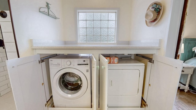 washroom featuring washer and clothes dryer, laundry area, and wood finished floors