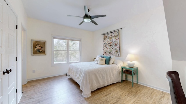bedroom with wood finished floors, baseboards, and ceiling fan