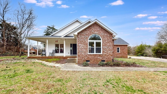 view of front of home featuring a porch, a front lawn, brick siding, and crawl space