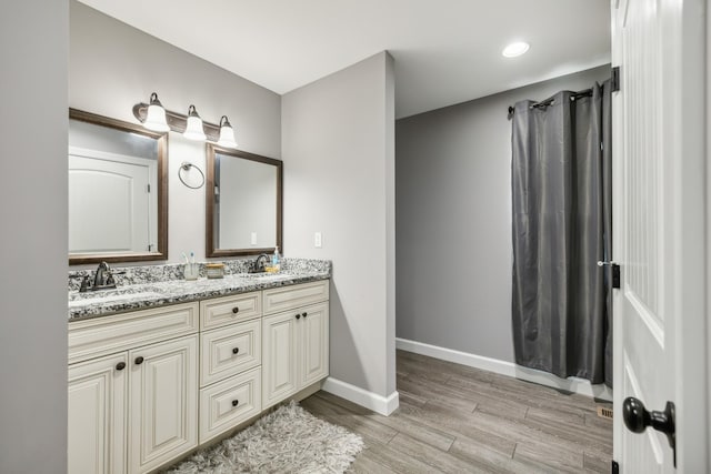 855 Sneed Blvd, Lafayette, TN 37083 - full bath featuring baseboards, double vanity, a sink, and wood finished floors