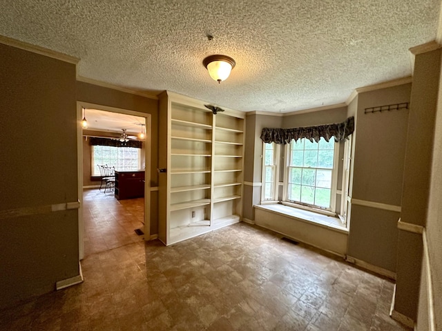 2311 Center Point Rd, Hendersonville, TN 37075 - empty room with ornamental molding, built in features, baseboards, a textured ceiling, and tile patterned floors