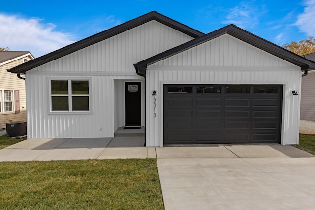 3313 Parker Ln, Chattanooga, TN 37419 - view of front of property featuring a garage, concrete driveway, central AC, and board and batten siding
