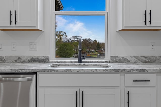 3313 Parker Ln, Chattanooga, TN 37419 - kitchen featuring stainless steel dishwasher, a sink, white cabinets, and light stone counters