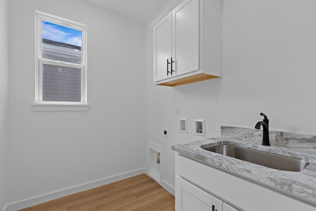 3313 Parker Ln, Chattanooga, TN 37419 - laundry area featuring hookup for an electric dryer, hookup for a washing machine, cabinet space, light wood-style floors, and baseboards