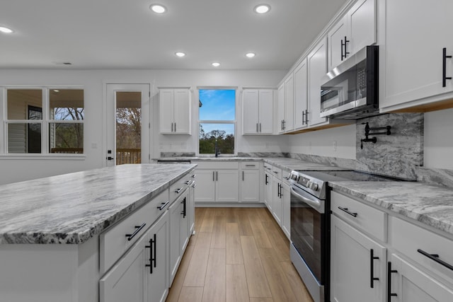 3313 Parker Ln, Chattanooga, TN 37419 - kitchen featuring appliances with stainless steel finishes, recessed lighting, white cabinetry, light stone countertops, and a sink