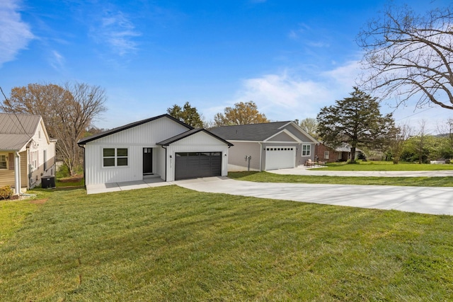3313 Parker Ln, Chattanooga, TN 37419 - view of front of home with concrete driveway, an attached garage, a front lawn, and cooling unit