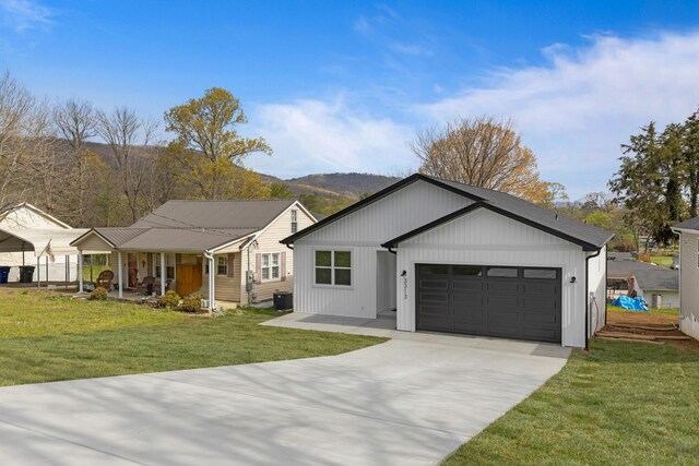 3313 Parker Ln, Chattanooga, TN 37419 - view of front of home with an attached garage, driveway, a front yard, and covered porch