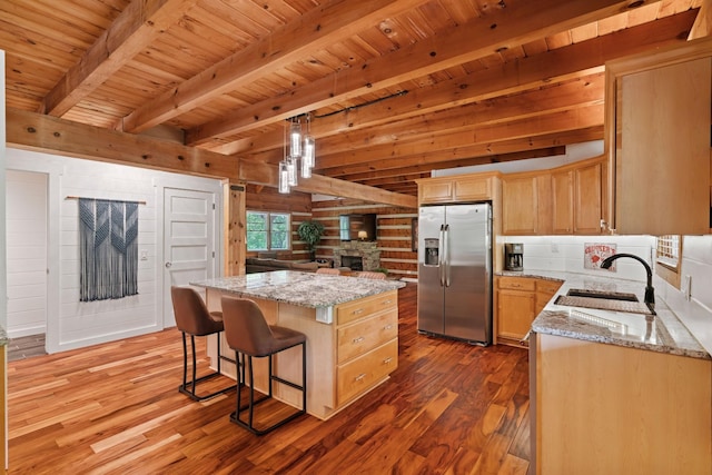 1708 Sugar Ridge Rd, Spring Hill, TN 37174 - kitchen featuring stainless steel refrigerator with ice dispenser, a sink, wood finished floors, a center island, and light stone counters