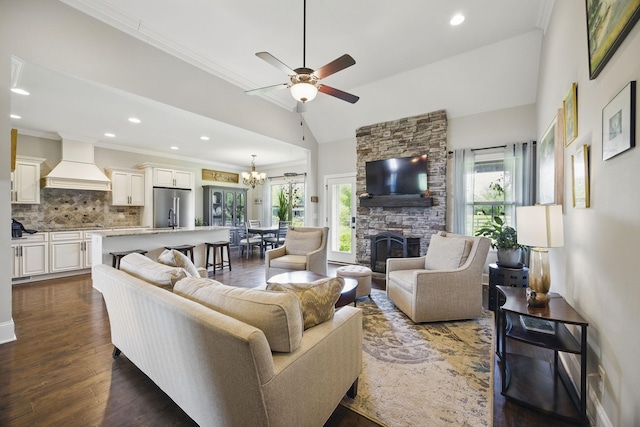 living room with crown molding, a fireplace, recessed lighting, and ceiling fan with notable chandelier