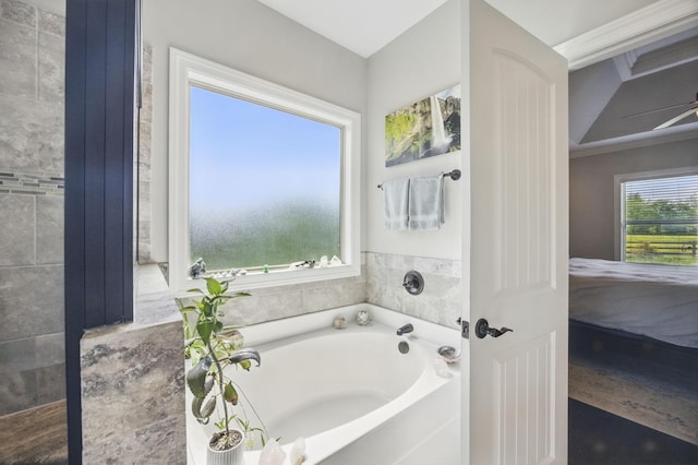 full bath featuring ensuite bath, a garden tub, and a ceiling fan