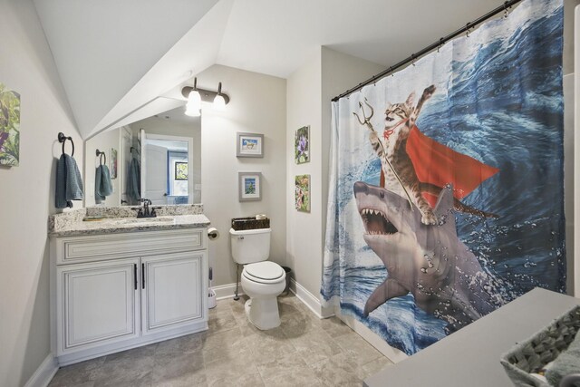 full bathroom featuring vanity, toilet, lofted ceiling, and baseboards