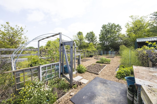 view of yard featuring a vegetable garden and fence