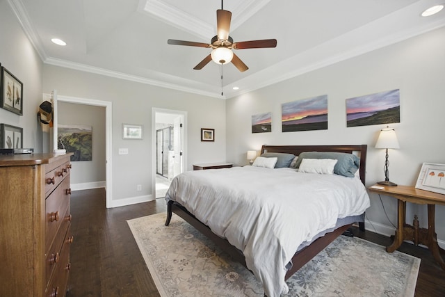 bedroom featuring a tray ceiling, recessed lighting, baseboards, dark wood finished floors, and crown molding