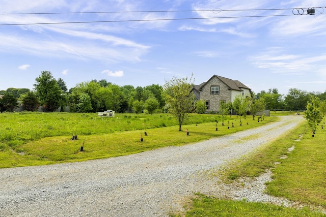 view of road featuring a rural view and driveway