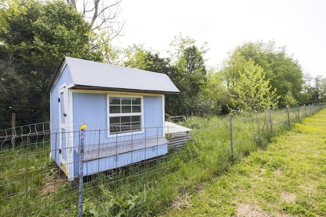 view of outbuilding with fence