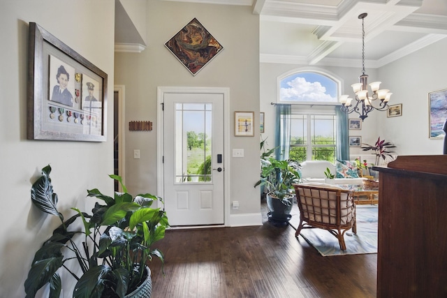 foyer entrance featuring ornamental molding, dark wood-style flooring, an inviting chandelier, beamed ceiling, and coffered ceiling