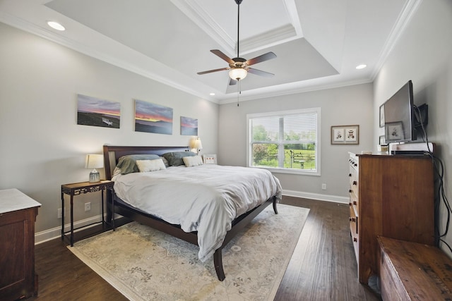 bedroom with crown molding, a raised ceiling, baseboards, and dark wood-style floors
