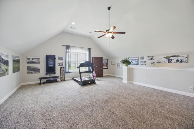 exercise area featuring carpet, baseboards, visible vents, ceiling fan, and vaulted ceiling