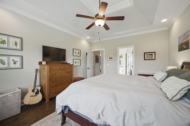 bedroom with a tray ceiling, crown molding, recessed lighting, and wood finished floors