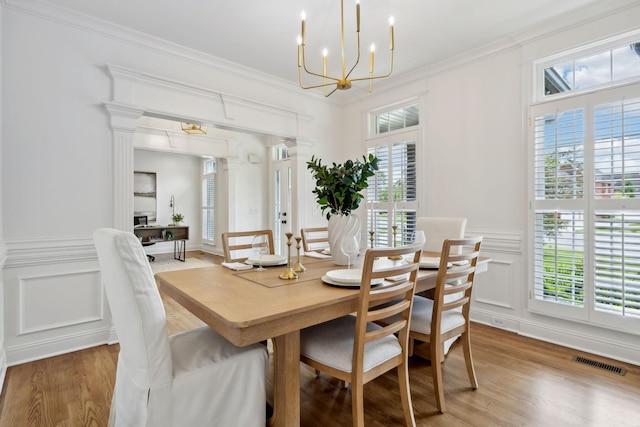 1207 Mullberry Ct, Murfreesboro, TN 37130 - dining area featuring a chandelier, light wood-style floors, visible vents, and a decorative wall