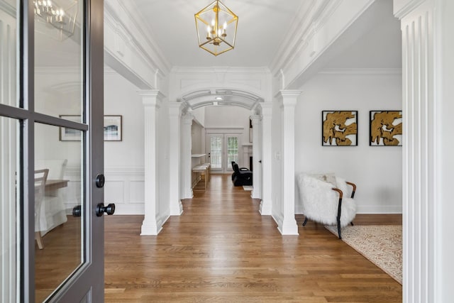 1207 Mullberry Ct, Murfreesboro, TN 37130 - entrance foyer featuring wood finished floors, french doors, decorative columns, a notable chandelier, and arched walkways