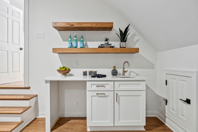 1207 Mullberry Ct, Murfreesboro, TN 37130 - bar with vaulted ceiling, baseboards, a sink, indoor wet bar, and light wood-style floors