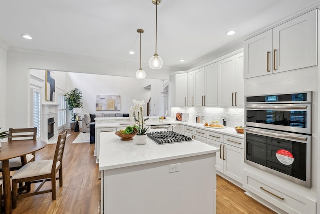 1207 Mullberry Ct, Murfreesboro, TN 37130 - kitchen with open floor plan, backsplash, light countertops, white cabinets, and appliances with stainless steel finishes