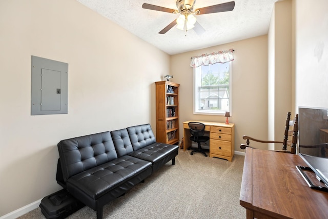 office area featuring electric panel, light colored carpet, ceiling fan, baseboards, and a textured ceiling