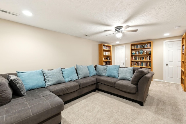 living area featuring a ceiling fan, light colored carpet, recessed lighting, baseboards, and built in shelves
