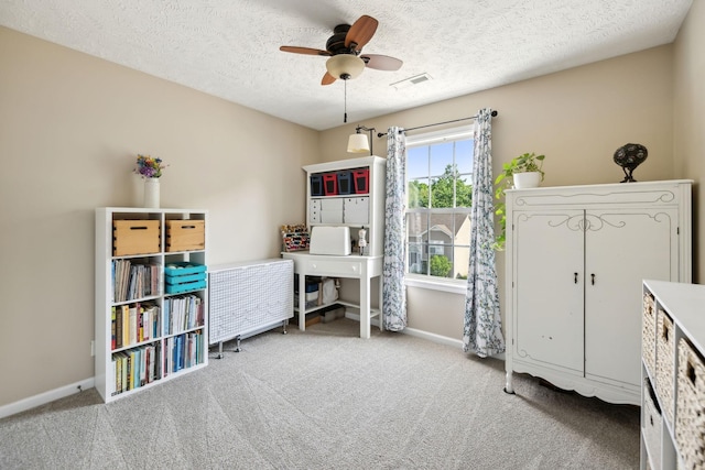 bedroom featuring carpet, baseboards, a textured ceiling, and ceiling fan