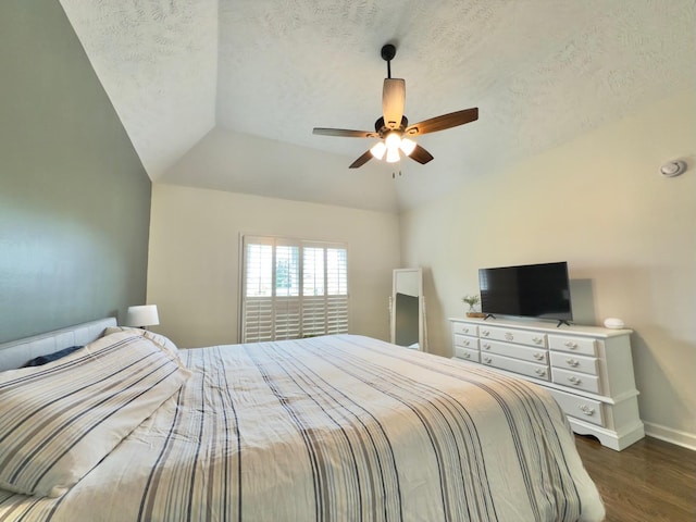 bedroom featuring baseboards, dark wood-style flooring, ceiling fan, and a textured ceiling