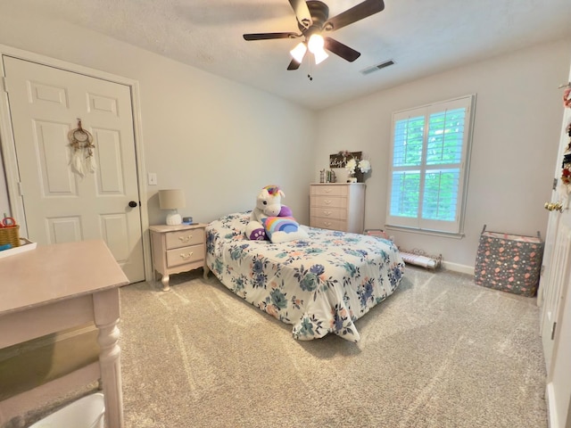 bedroom featuring light colored carpet, visible vents, and ceiling fan