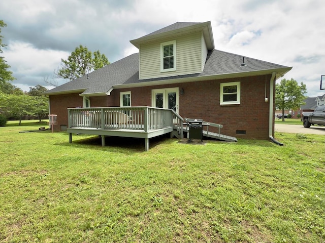 back of property with crawl space, a lawn, a wooden deck, brick siding, and roof with shingles