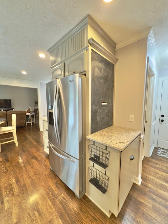 kitchen featuring stainless steel fridge with ice dispenser, crown molding, a textured ceiling, and dark wood-type flooring