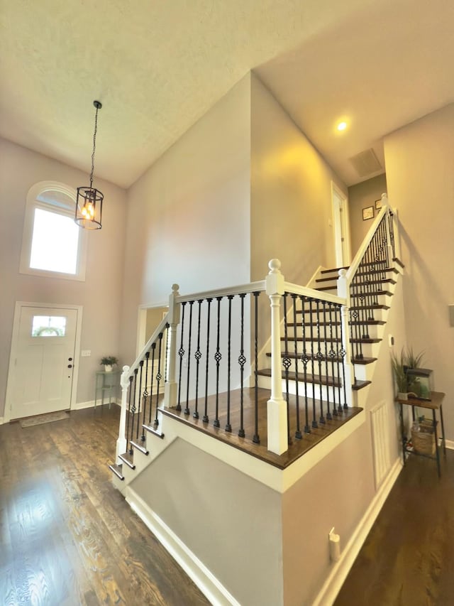 foyer featuring stairway, baseboards, and wood finished floors