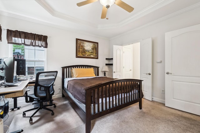 carpeted bedroom featuring crown molding, baseboards, a raised ceiling, and ceiling fan