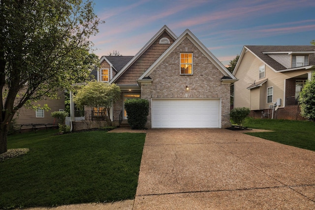 view of front of home featuring concrete driveway, a yard, brick siding, and an attached garage