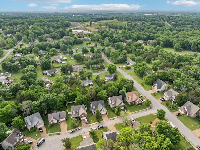 birds eye view of property with a view of trees and a residential view