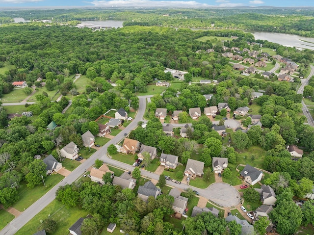 birds eye view of property featuring a water view, a view of trees, and a residential view