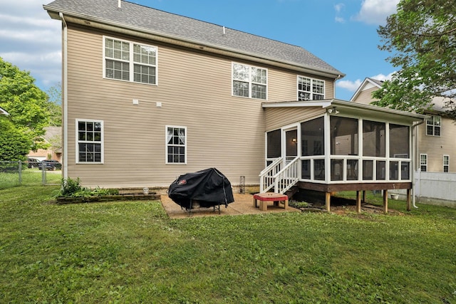 back of property featuring a yard, fence, a sunroom, and a gate