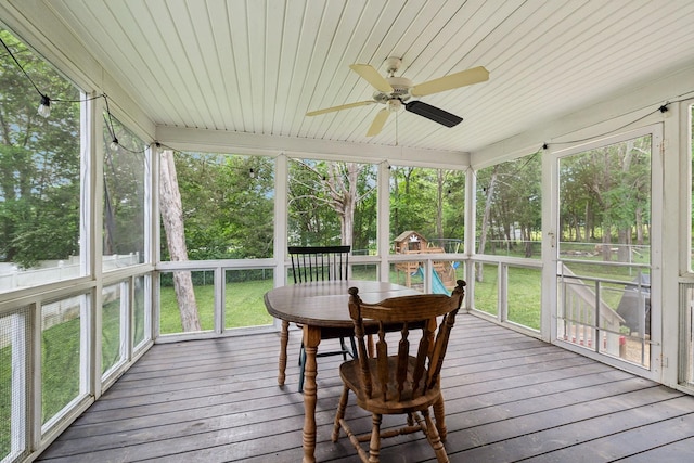 sunroom / solarium featuring outdoor dining space, a ceiling fan, and plenty of natural light