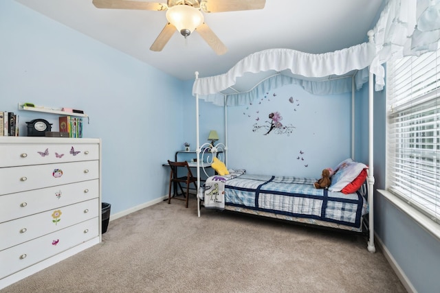 carpeted bedroom with baseboards and a ceiling fan