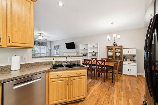 kitchen with a peninsula, a sink, freestanding refrigerator, dishwasher, and light wood-style floors