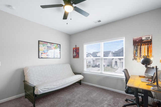 carpeted office space featuring visible vents, baseboards, and a ceiling fan