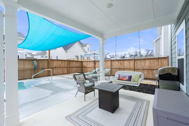 view of patio / terrace with a fenced backyard, an outdoor living space with a fire pit, and grilling area