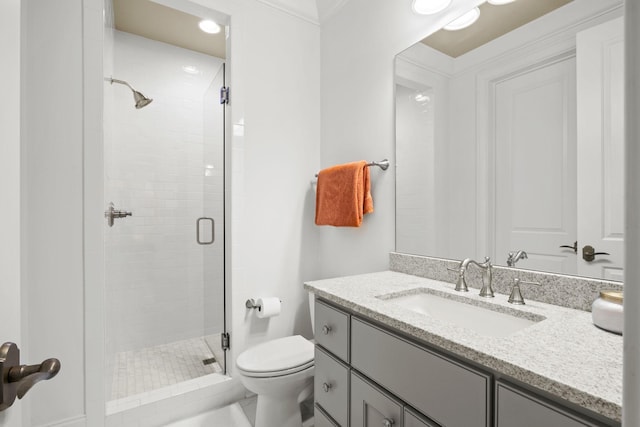 full bath with toilet, vanity, and a shower stall