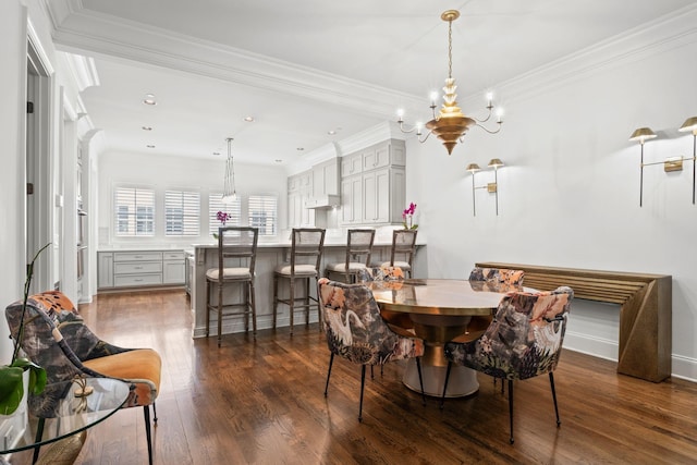 dining area with crown molding, a chandelier, and dark wood-style floors