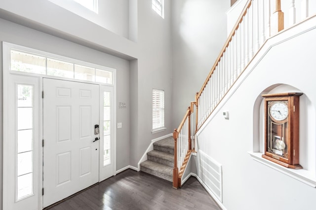 1040 Mansker Farm Blvd, Hendersonville, TN 37075 - entryway featuring dark wood-style flooring, plenty of natural light, a towering ceiling, stairs, and baseboards
