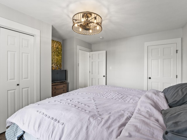 bedroom with a closet and a notable chandelier