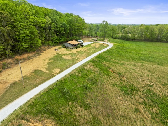birds eye view of property featuring a wooded view